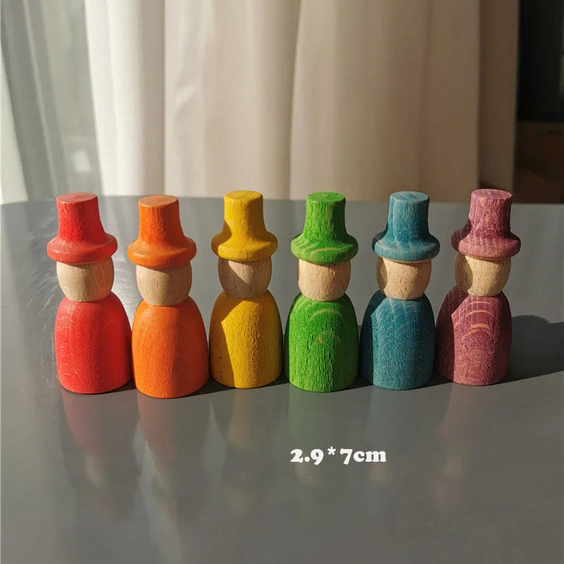 Set of colorful wooden figures with different colored hats on a gray surface.