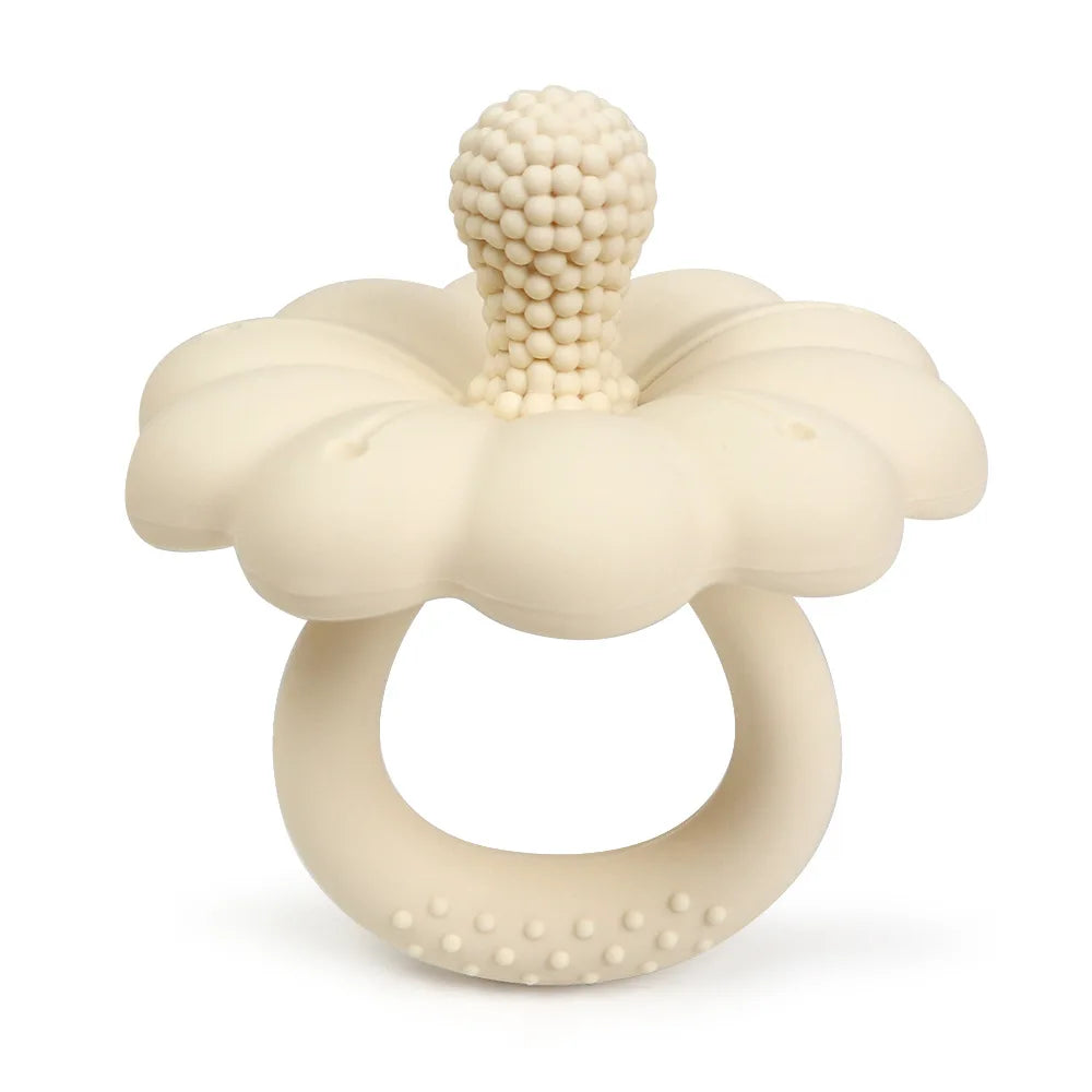 Beige flower-shaped teething ring on a white background