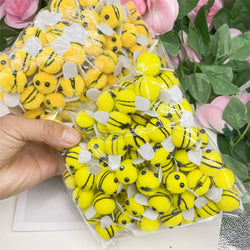 Yellow Pompom Bees DIY Toy Craft Supplies in a hand, ideal for children's creative projects and DIY crafts, available in various package sizes.