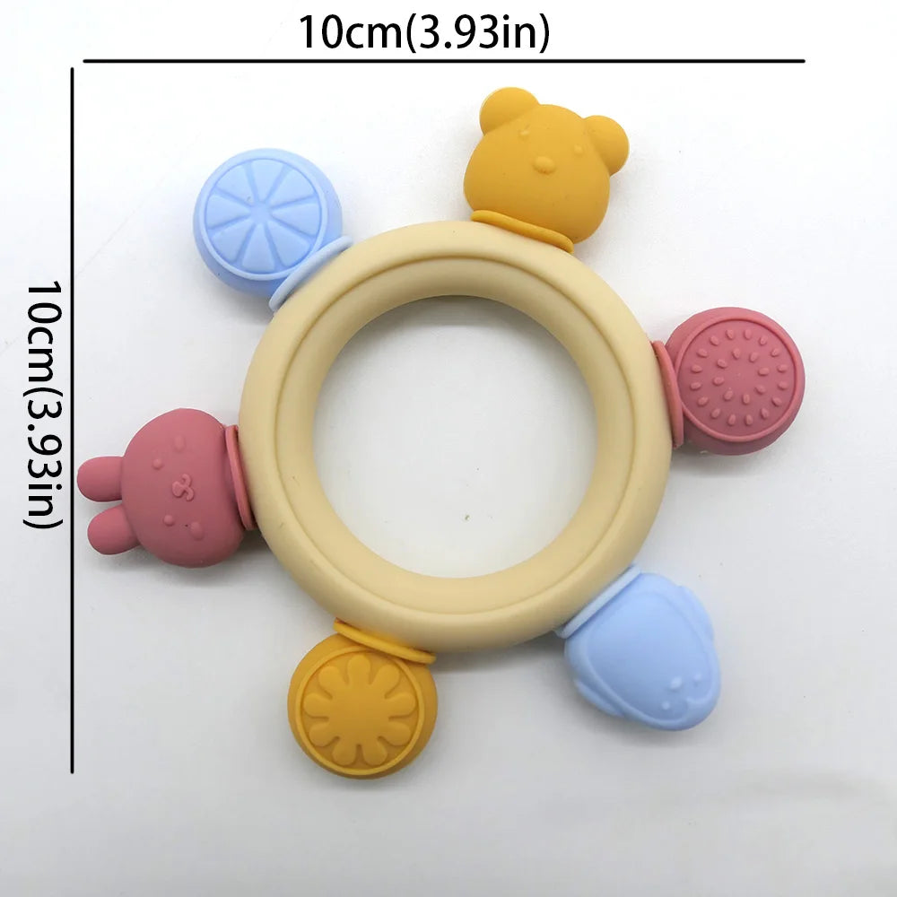 Colorful baby teething ring with various textures and shapes on a white background