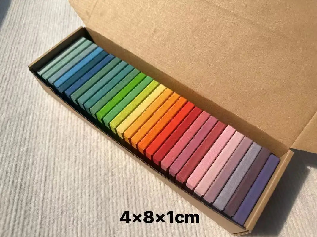 Set of colorful pastels in a cardboard box on a light gray surface