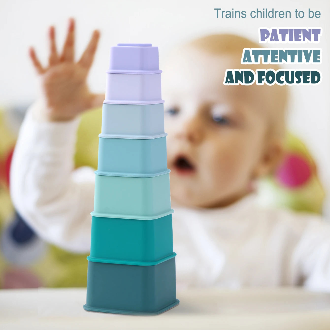 Baby reaching for a tower of silicone nesting cups