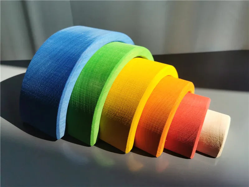 Set of colorful wooden archs in blue, green, yellow, orange, and red on a dark surface.