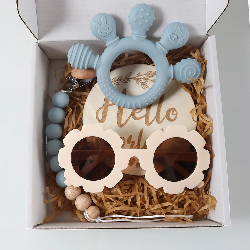 Baby teething toy set with blue and beige items in a decorative box.