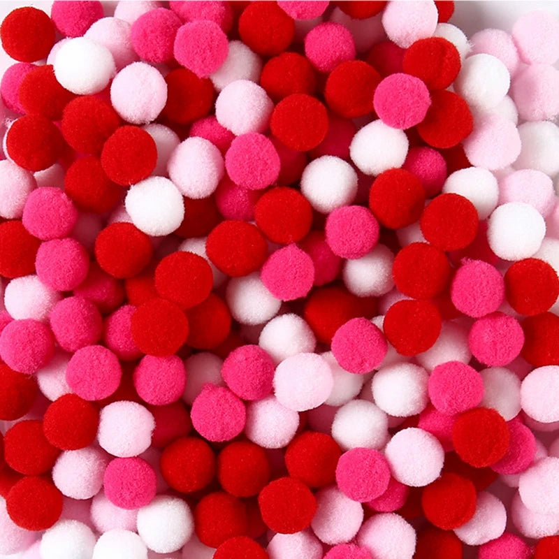 Close-up of red, pink, and white pom-poms.