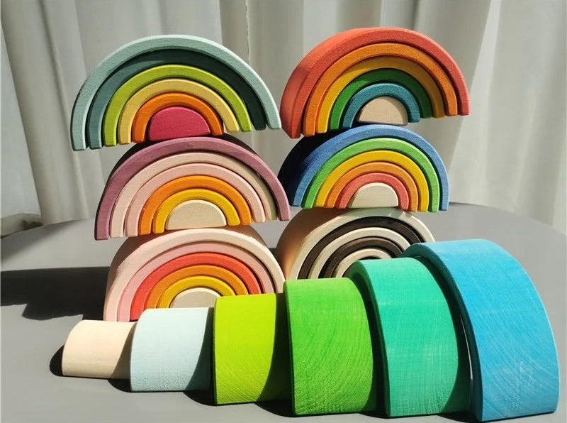Set of colorful wooden rainbow toys on a neutral background
