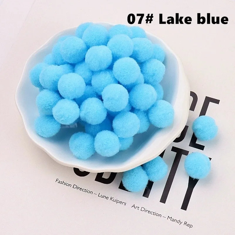 Blue pom-poms in a white bowl on a magazine background