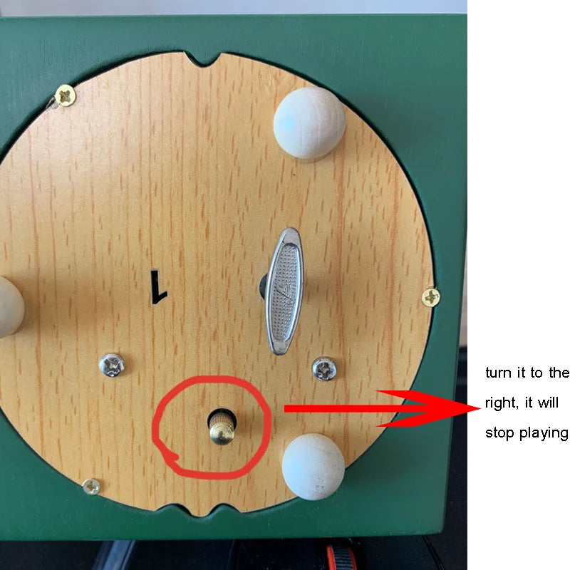 Wooden device with a ball mechanism and text indicating a control action.