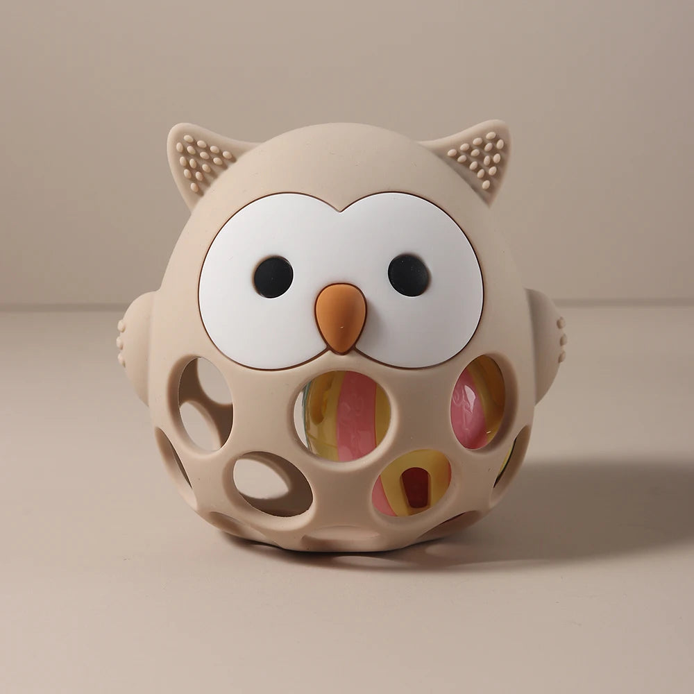 Owl-shaped toy with colorful holes on a beige background