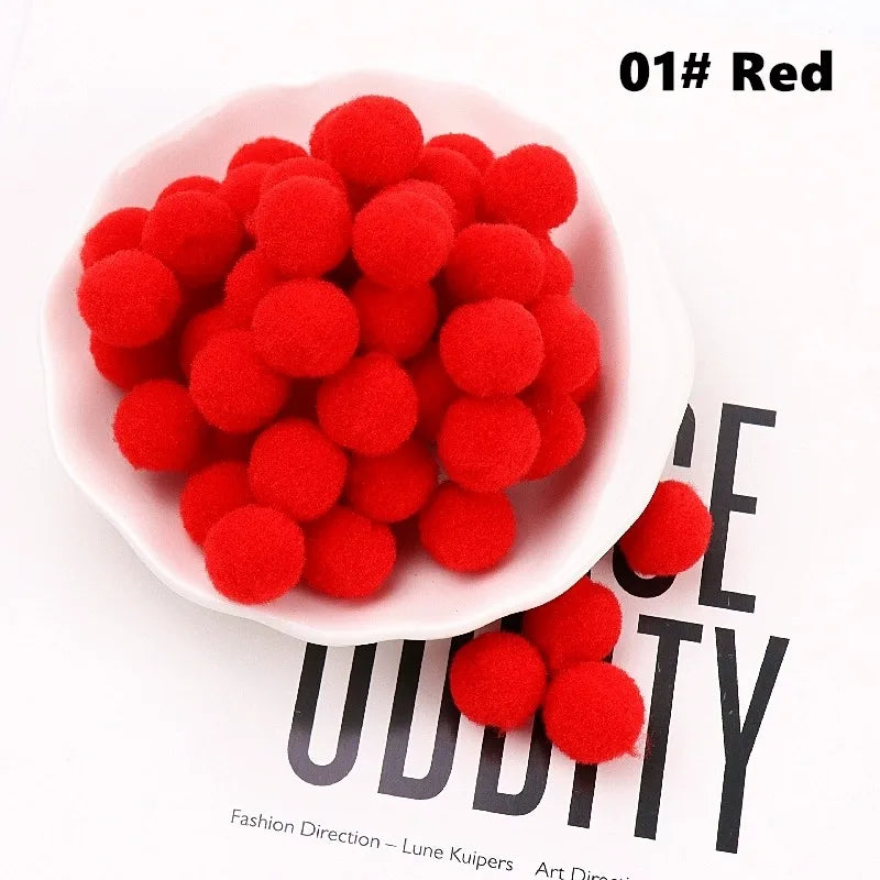 Red pom-poms in a white bowl on a magazine background