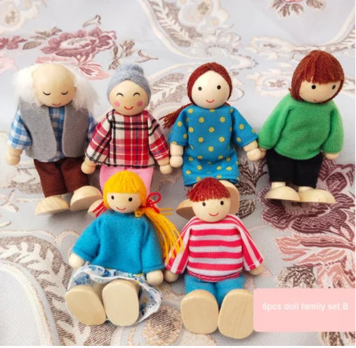Set of wooden dolls dressed in colorful clothing on a patterned surface