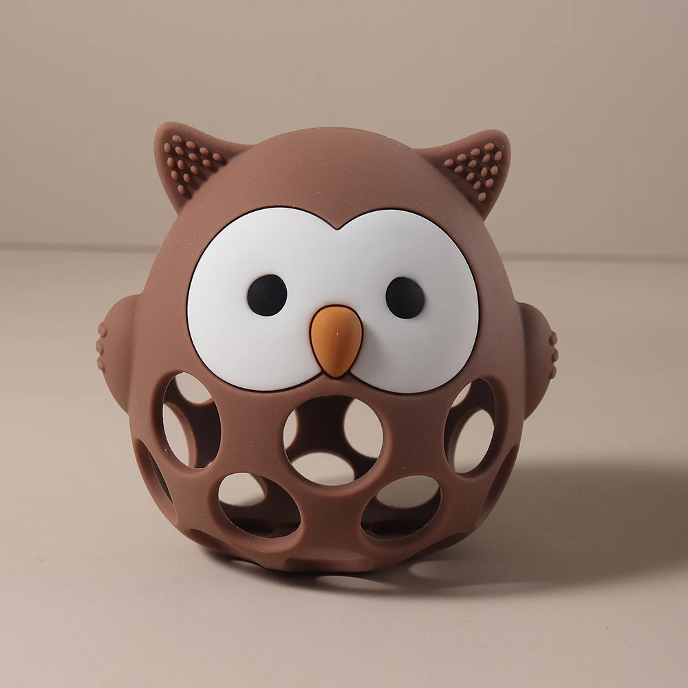Brown owl-shaped toy with a white face on a beige background