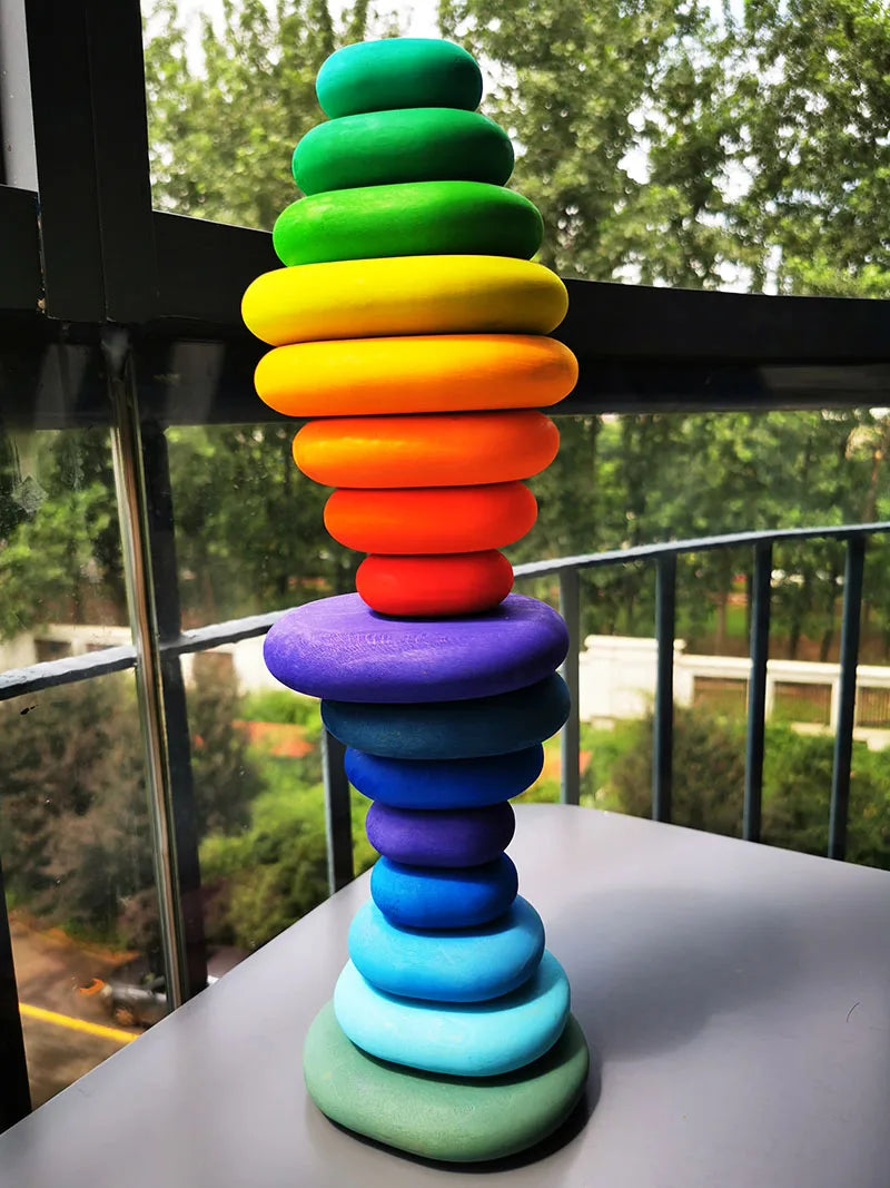 Colorful stack of rings on a table with a blurred outdoor background