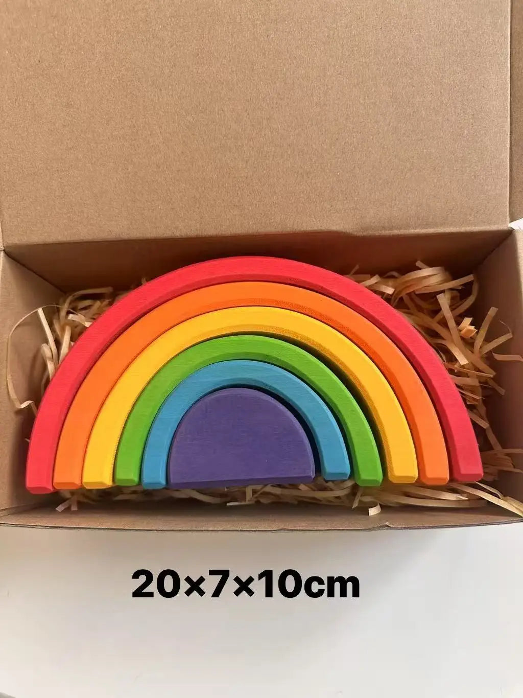 Colorful wooden rainbow toy in a cardboard box with dimensions displayed.