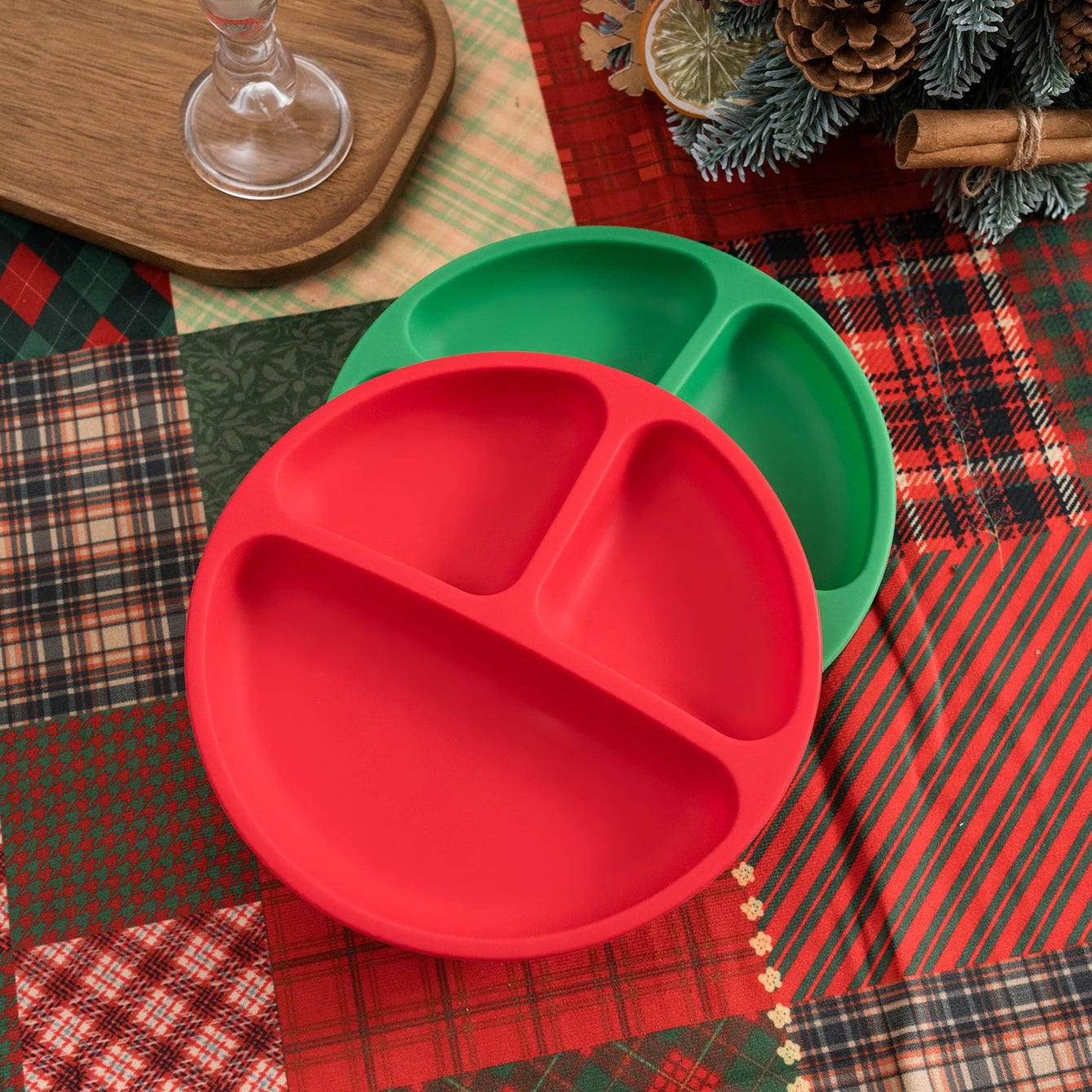 Red round silicone divided plate on Christmas plaid