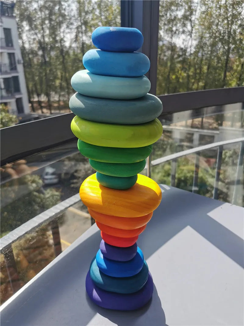 Colorful stacking toy on a surface with a window view in the background