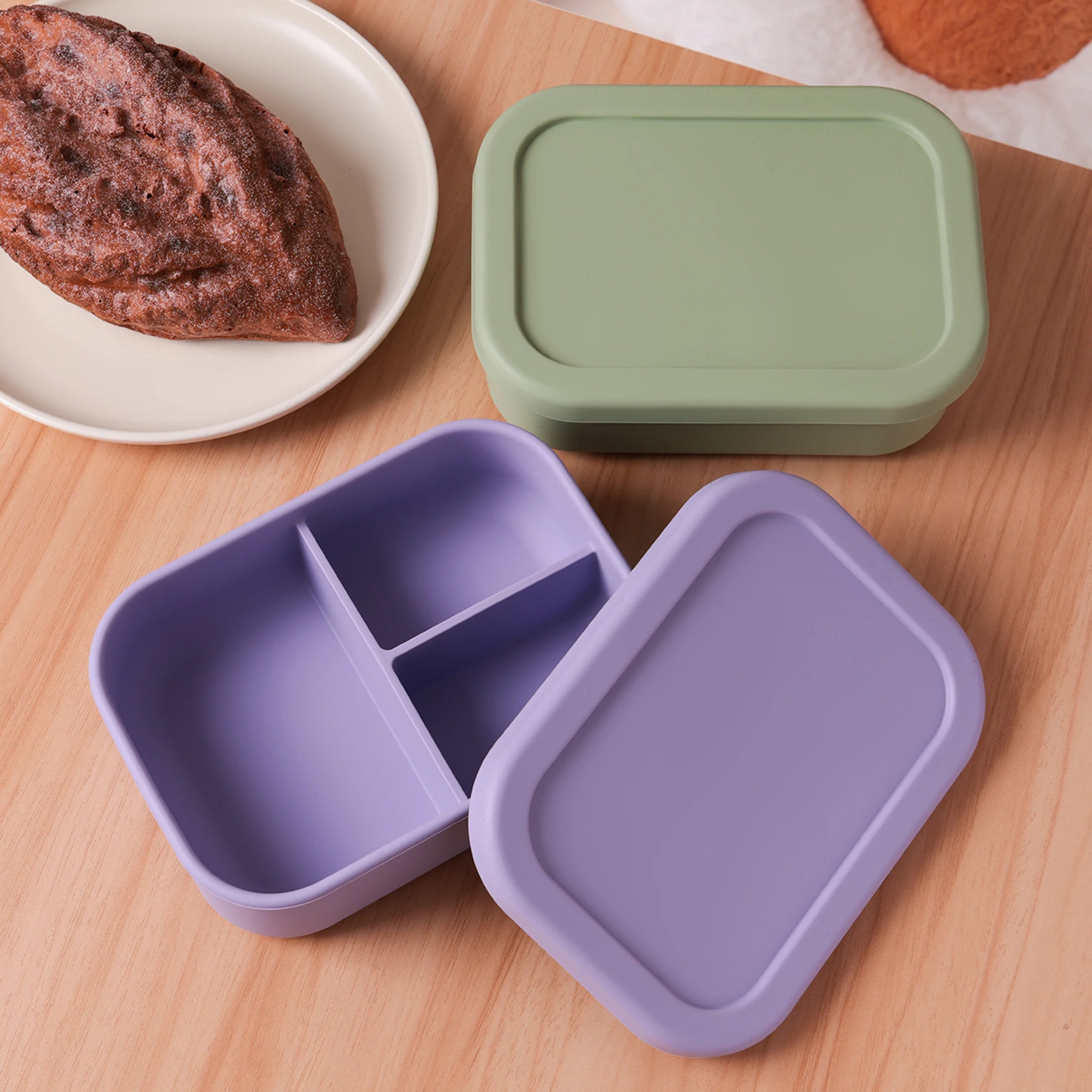 Lavender bento box open beside a sage lid