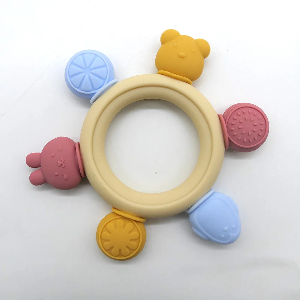 Colorful baby teething ring with various textures on a white background