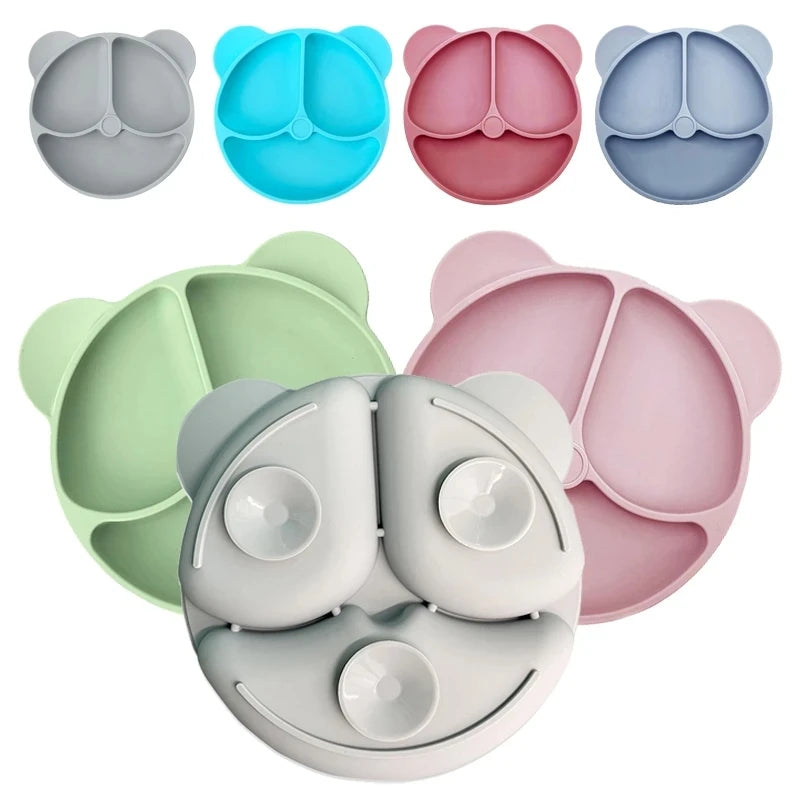 Set of colorful silicone bear-shaped bowls on a white background