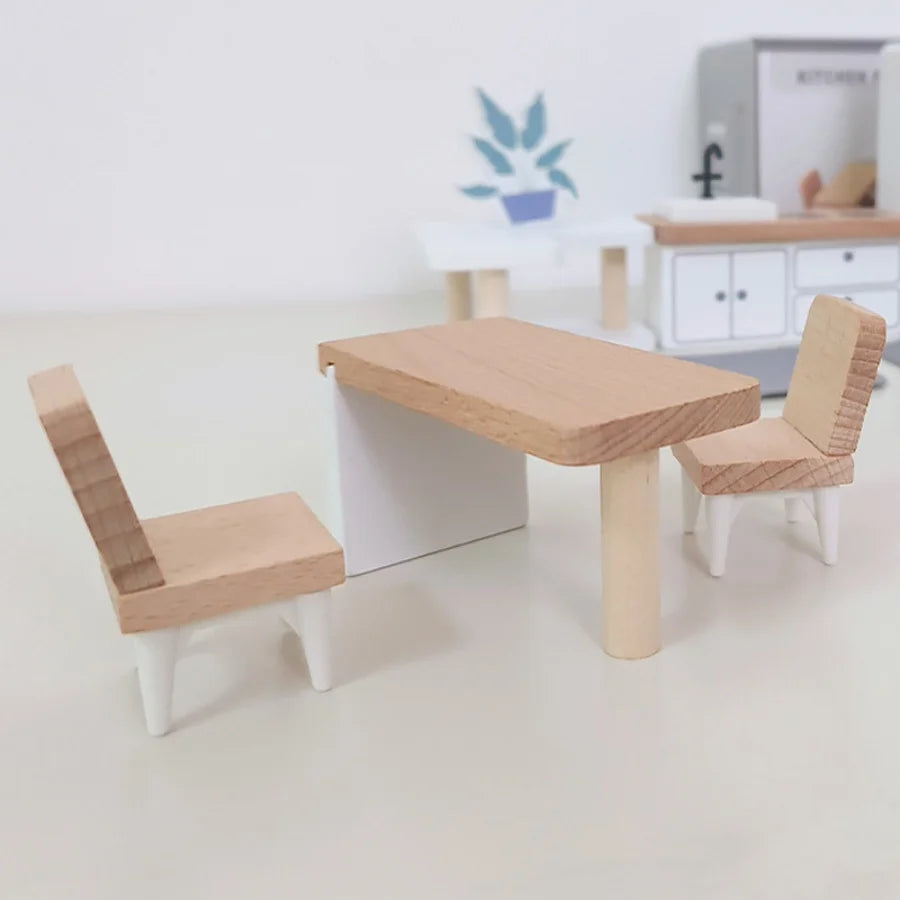 Children's wooden table and chairs set on a white floor with a blurred background
