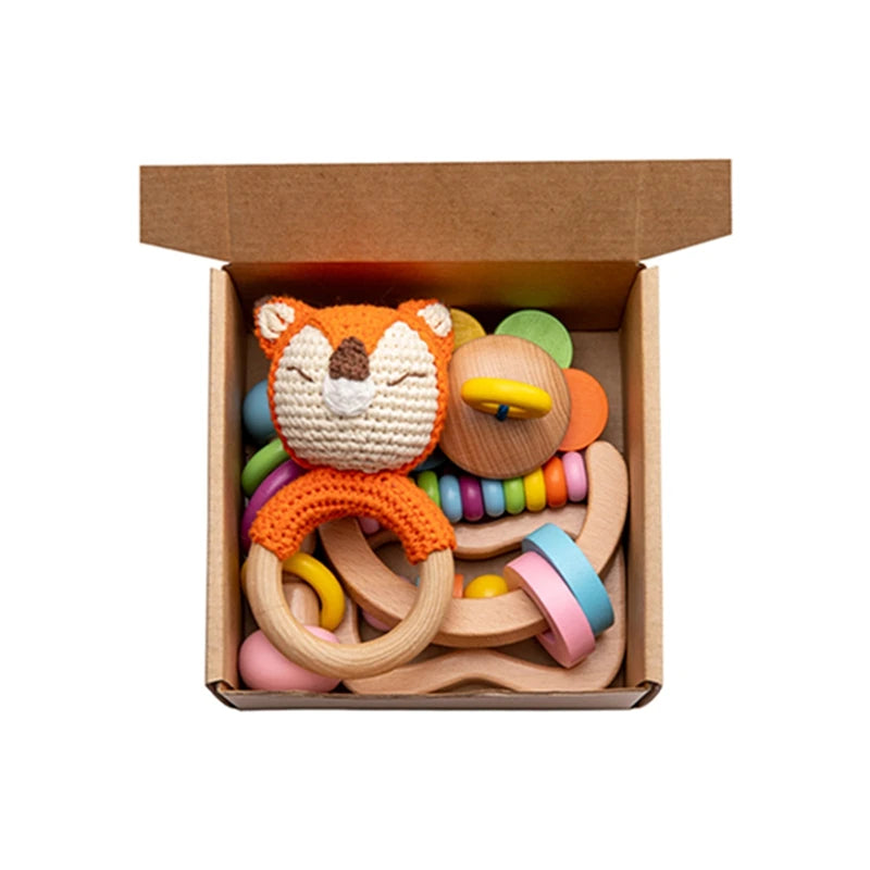 Wooden Baby Rattle Gift Set featuring a variety of Montessori-inspired wooden rattles in a box, designed for sensory development and engagement for infants.
