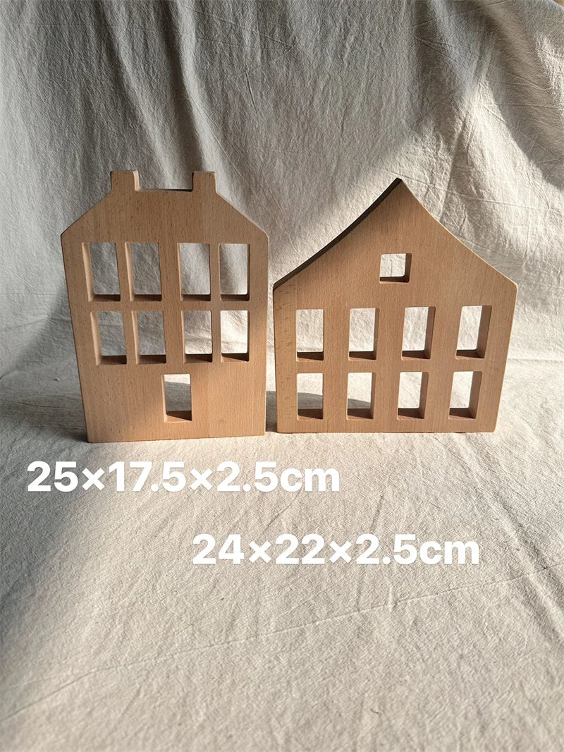 Two wooden house-shaped objects on a white fabric background with measurements.