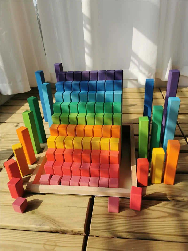 Colorful wooden blocks arranged to resemble a chair on a wooden surface.