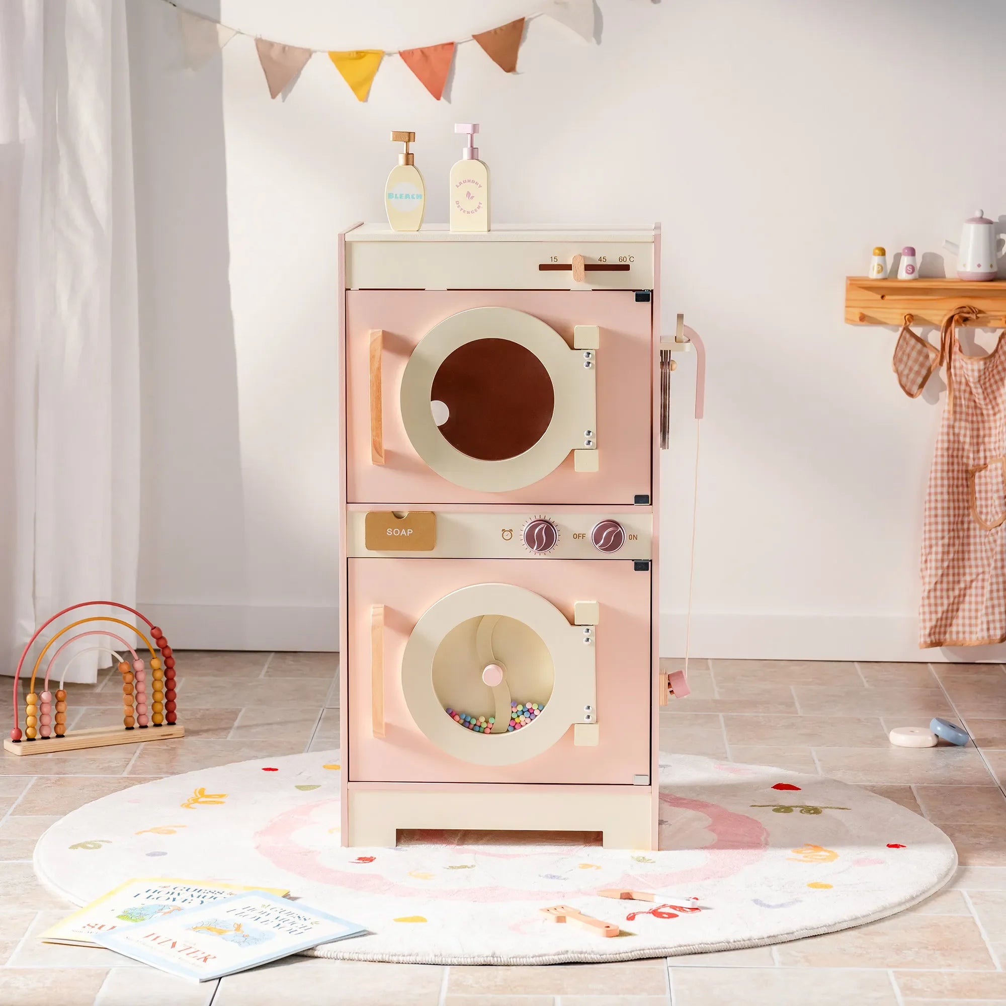 Children's toy dryer with a pink and beige color scheme in a room setting.