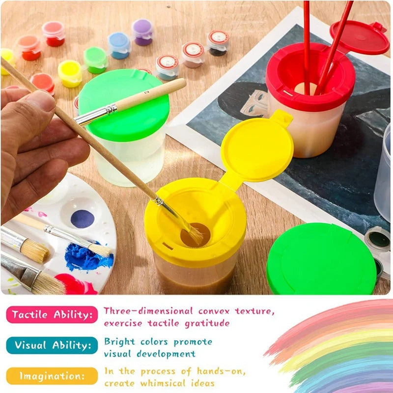 Colorful painting set with cups and brushes on a wooden surface