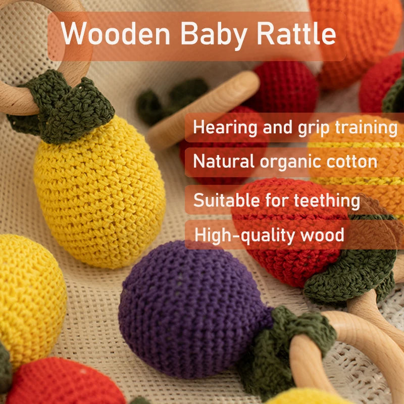 Colorful wooden baby rattle with text highlighting features on a textured surface.