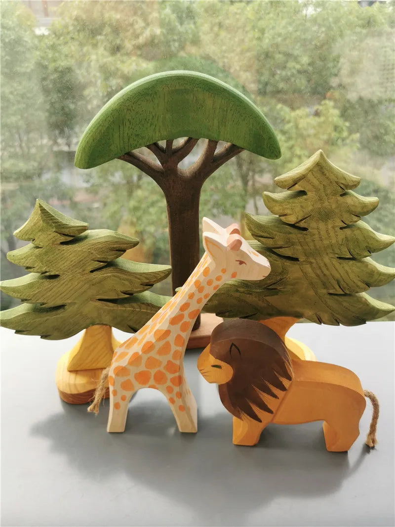 Wooden giraffe and lion toys with a tree and forest background