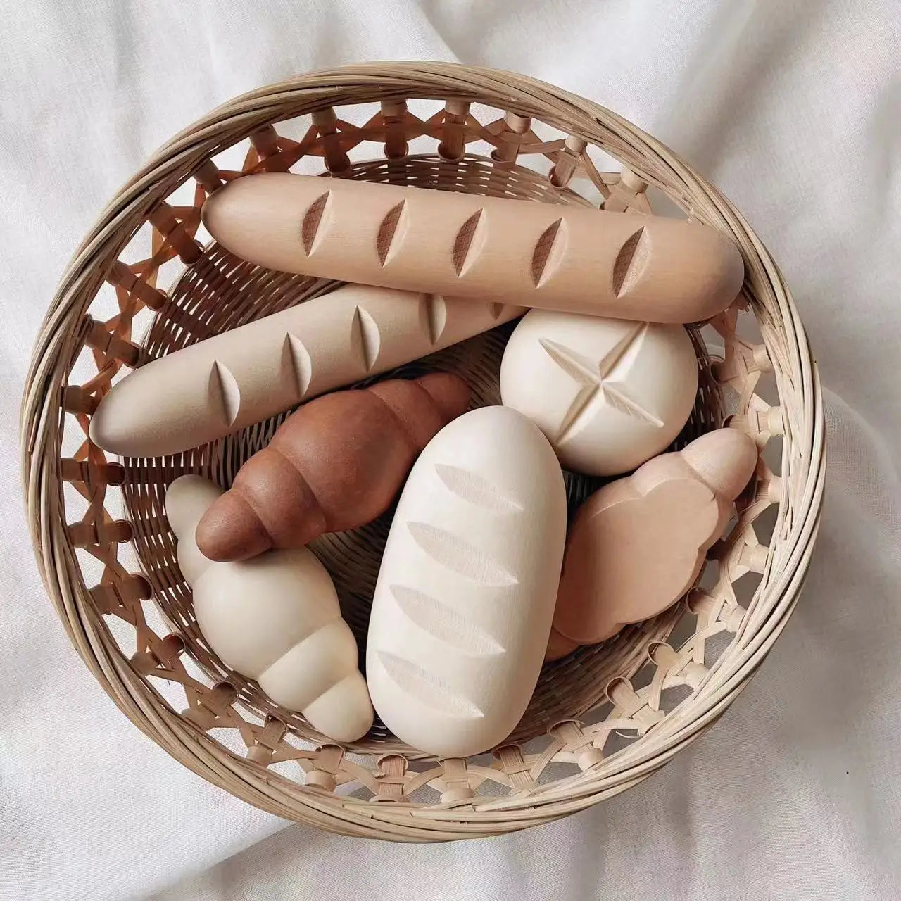 Basket with bread-shaped soaps on a light background