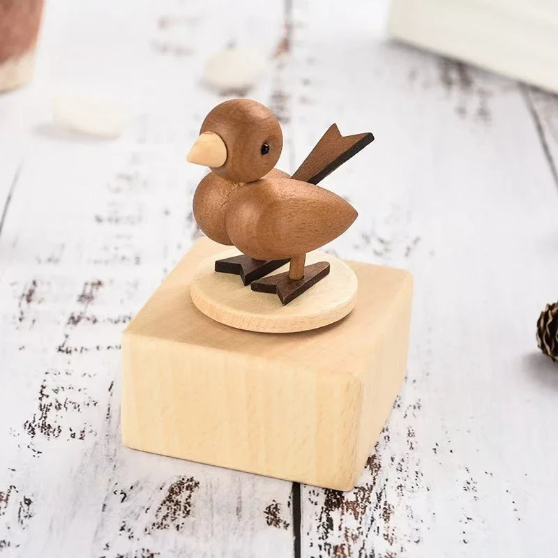 Wooden bird figurine on a wooden block with a white background | Oliver & Company Montessori toys