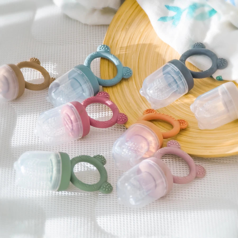 Bear fresh food feeders in soft colors on a woven mat
