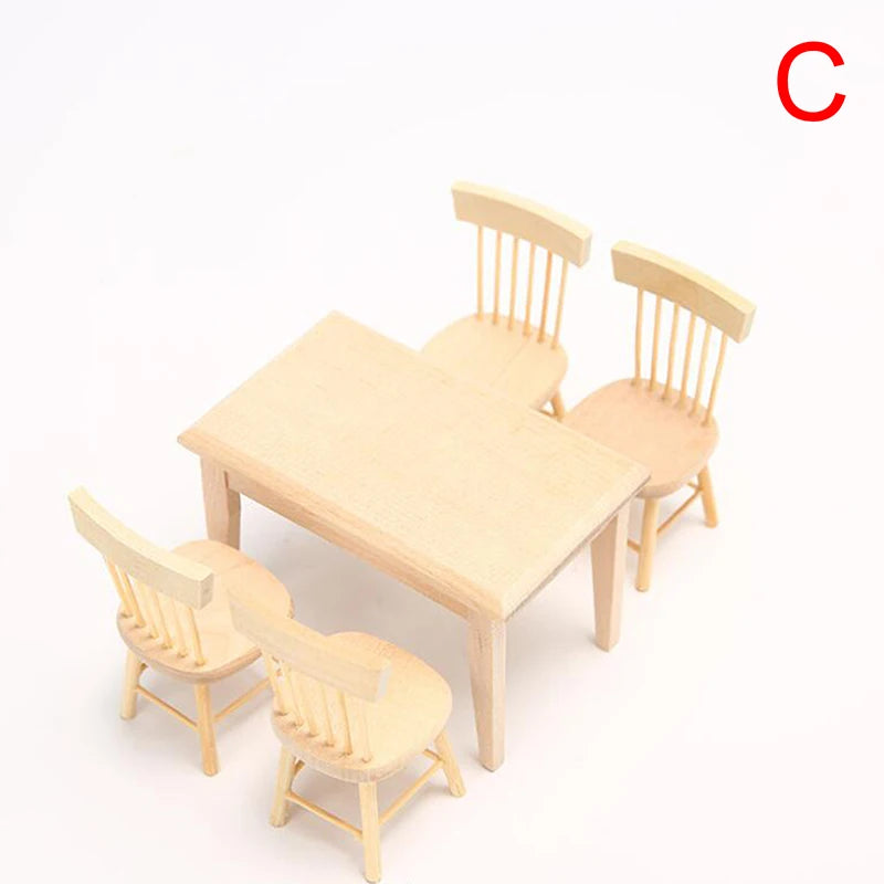 Wooden dining table with four chairs on a white background