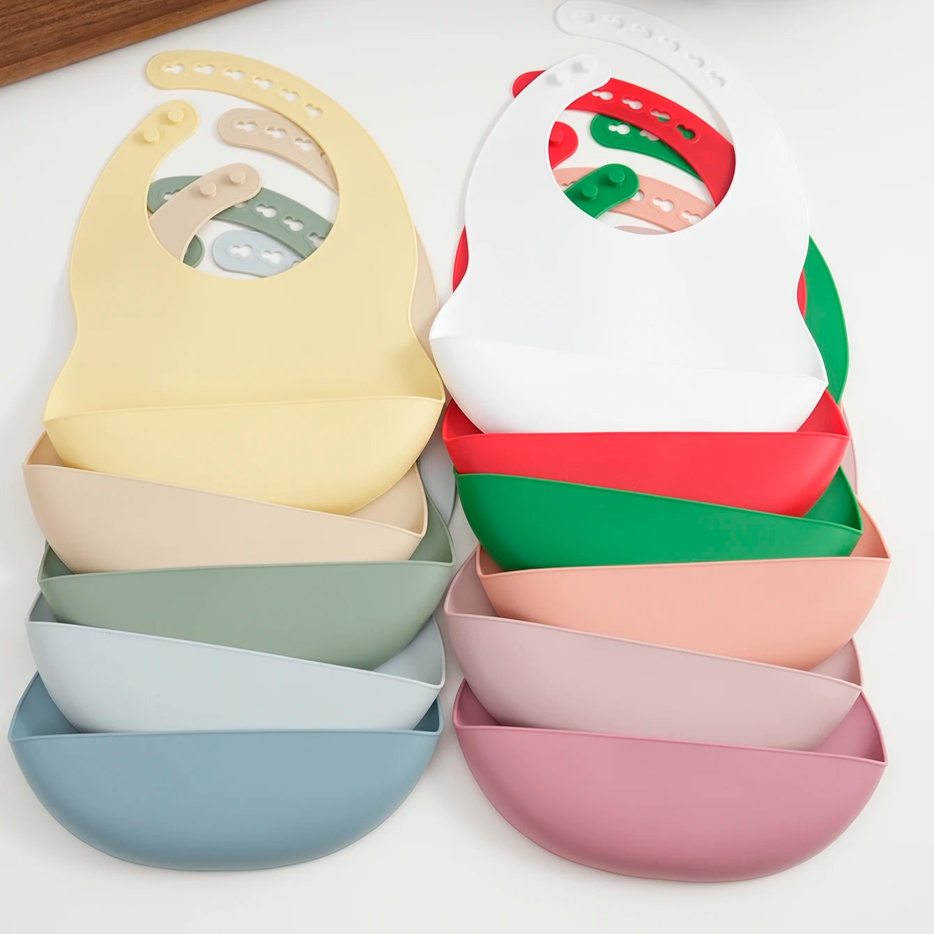 Stack of silicone bibs in Christmas and pastel colors