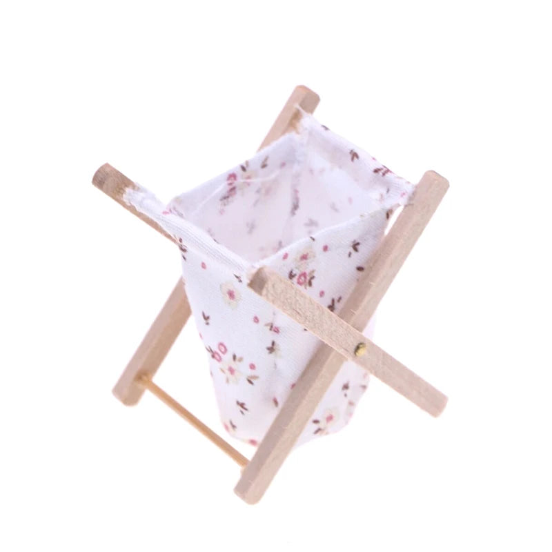 Small wooden stool with a floral-patterned white cloth draped over it on a white background
