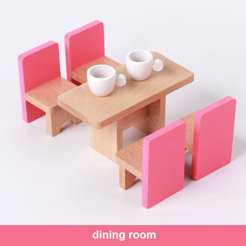 Miniature wooden dining table with pink chairs on a white background