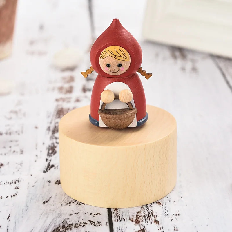 Wooden figurine of a girl in a red hood holding a basket on a wooden base. | Oliver & Company Montessori toys