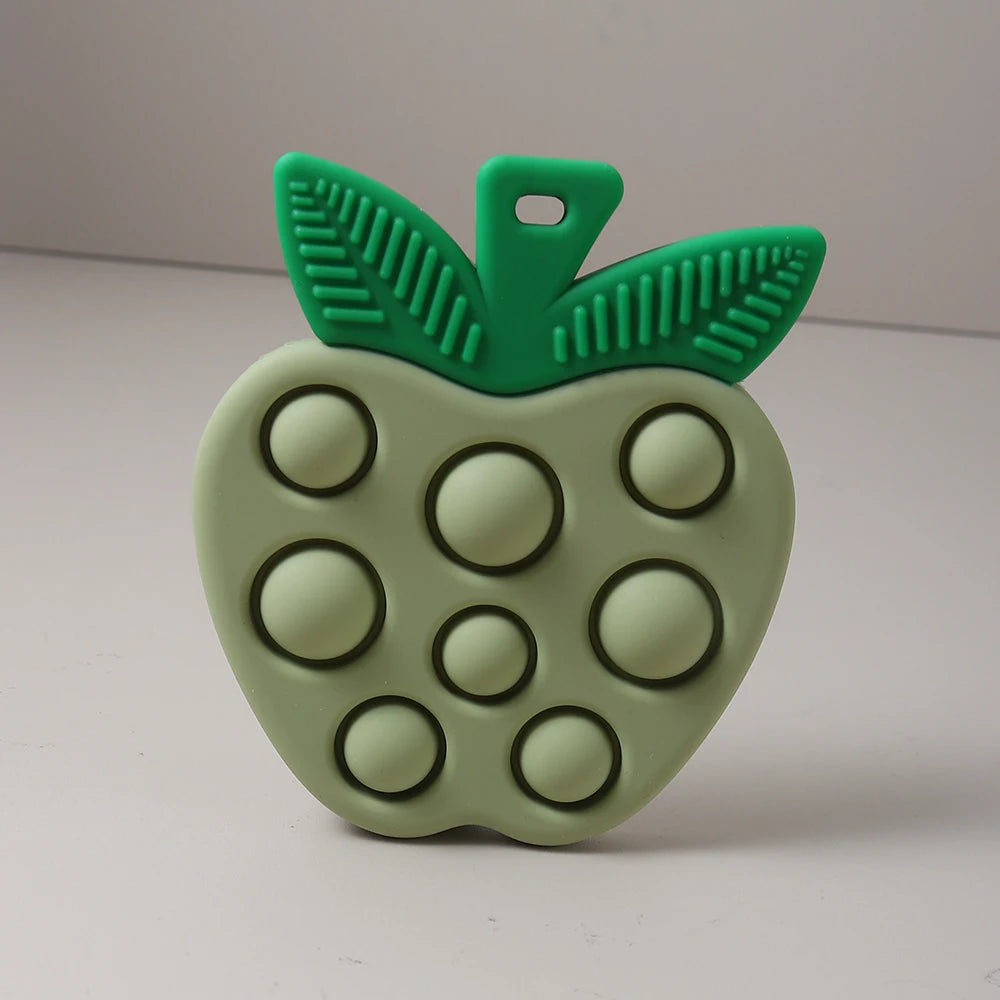 Green apple-shaped fidget toy with pop-it bubbles on a white background