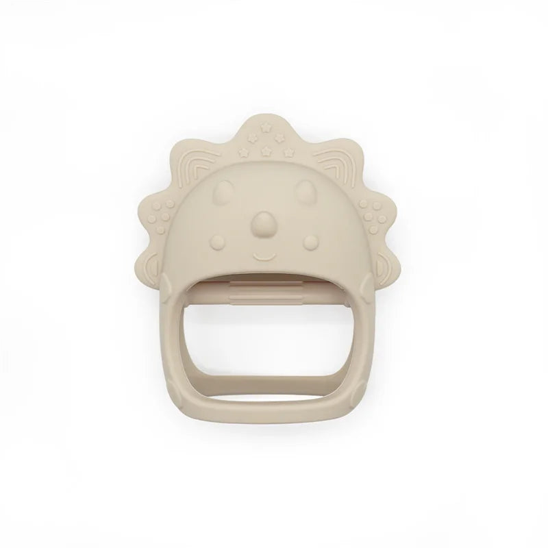 Beige dinosaur-shaped teething ring on a white background