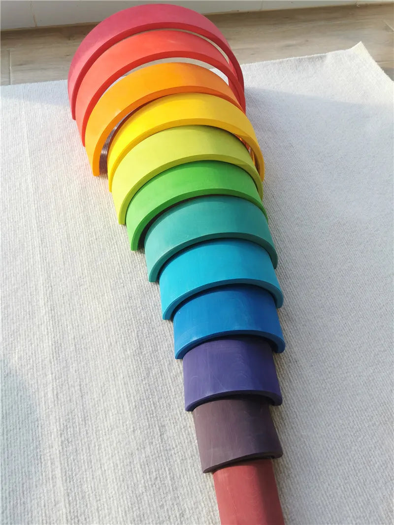 Stack of colorful silicone baking rings on a light gray surface
