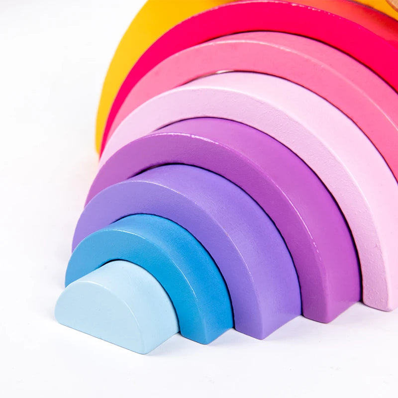 Stack of colorful wooden arch-shaped blocks on a white background