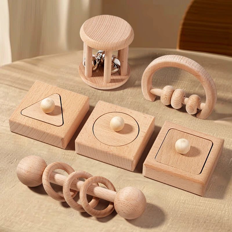 Set of wooden baby toys on a beige surface