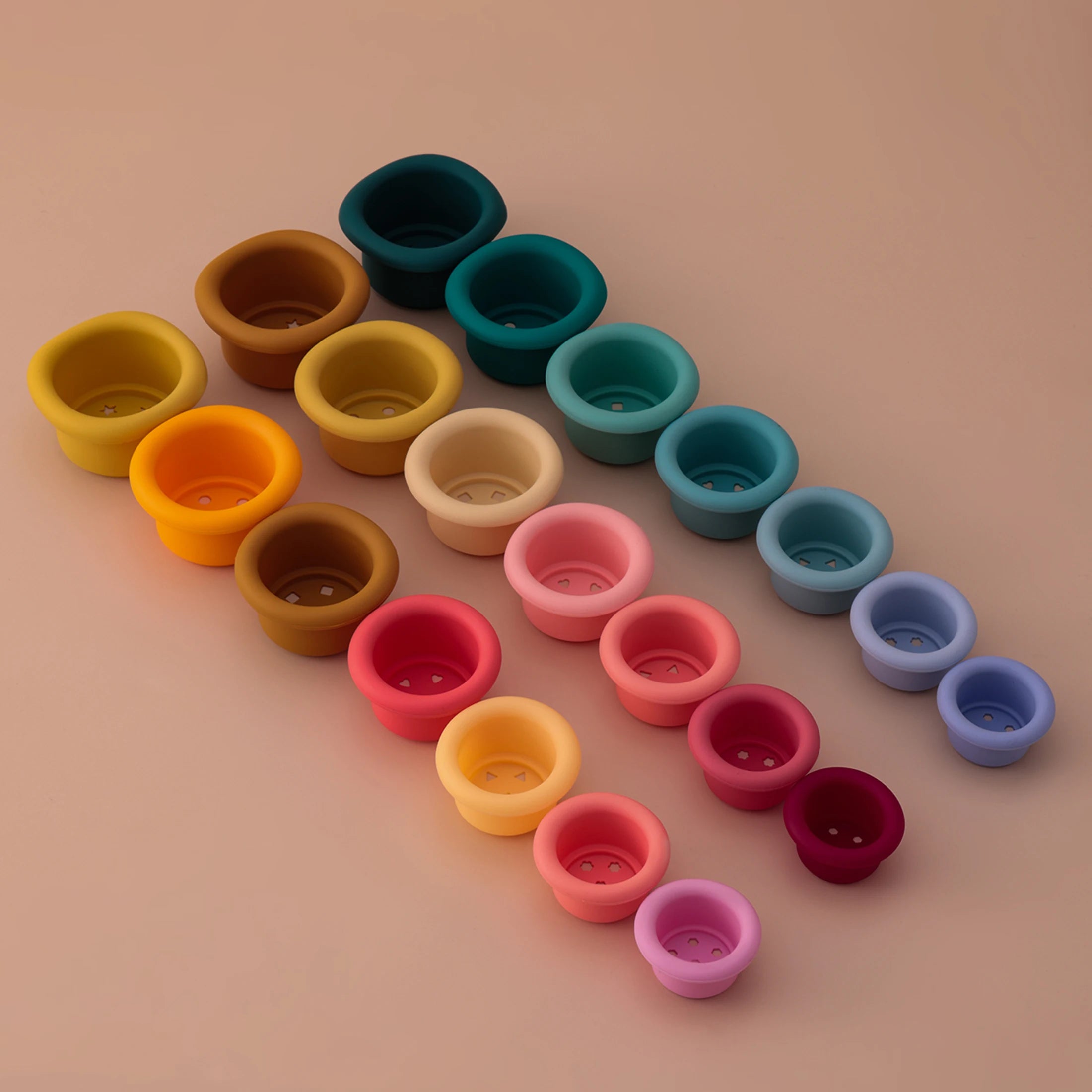 Silicone stacking cups laid out in rows by size