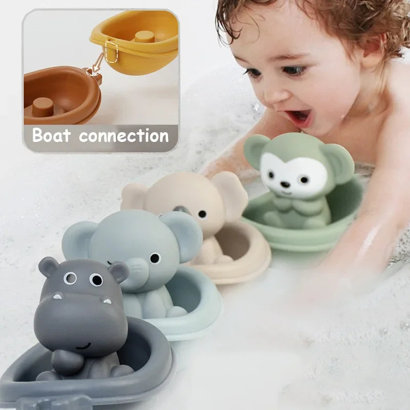 A baby bath toy set featuring animal-shaped boats in a bubble bath, including a gray hippo, a blue elephant, a beige giraffe, and a green monkey. An inset shows a yellow boat connected to the hippo boat with the text 'Boat connection'.