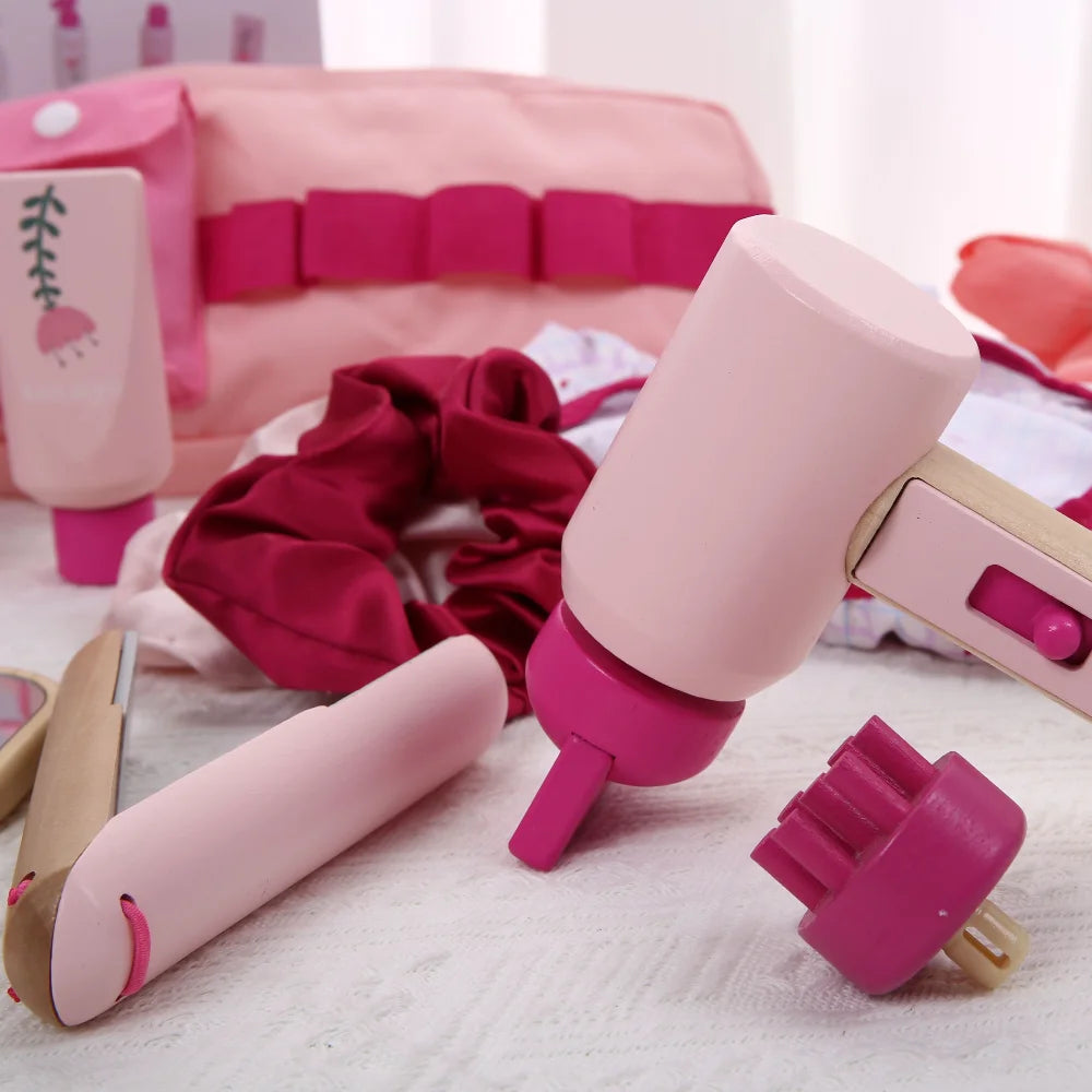 Pink hair styling tools on a white surface with a pink background