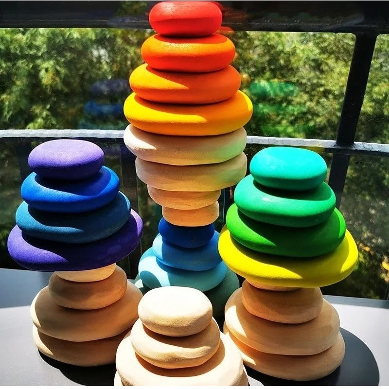 Colorful stack of wooden rings on a blurred natural background