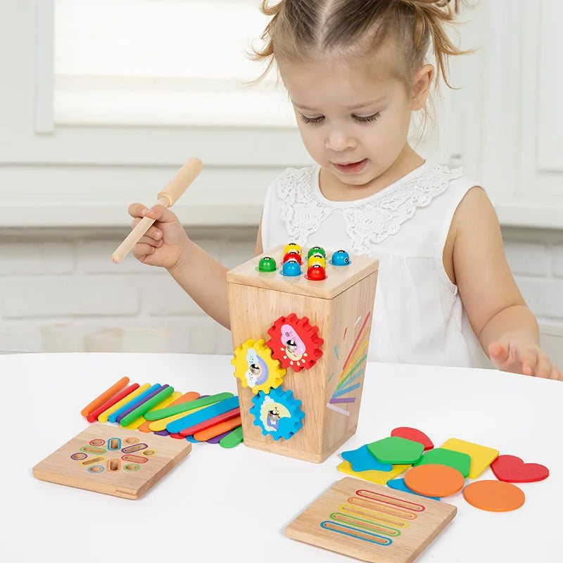 Child playing with a wooden educational toy set on a white surface.