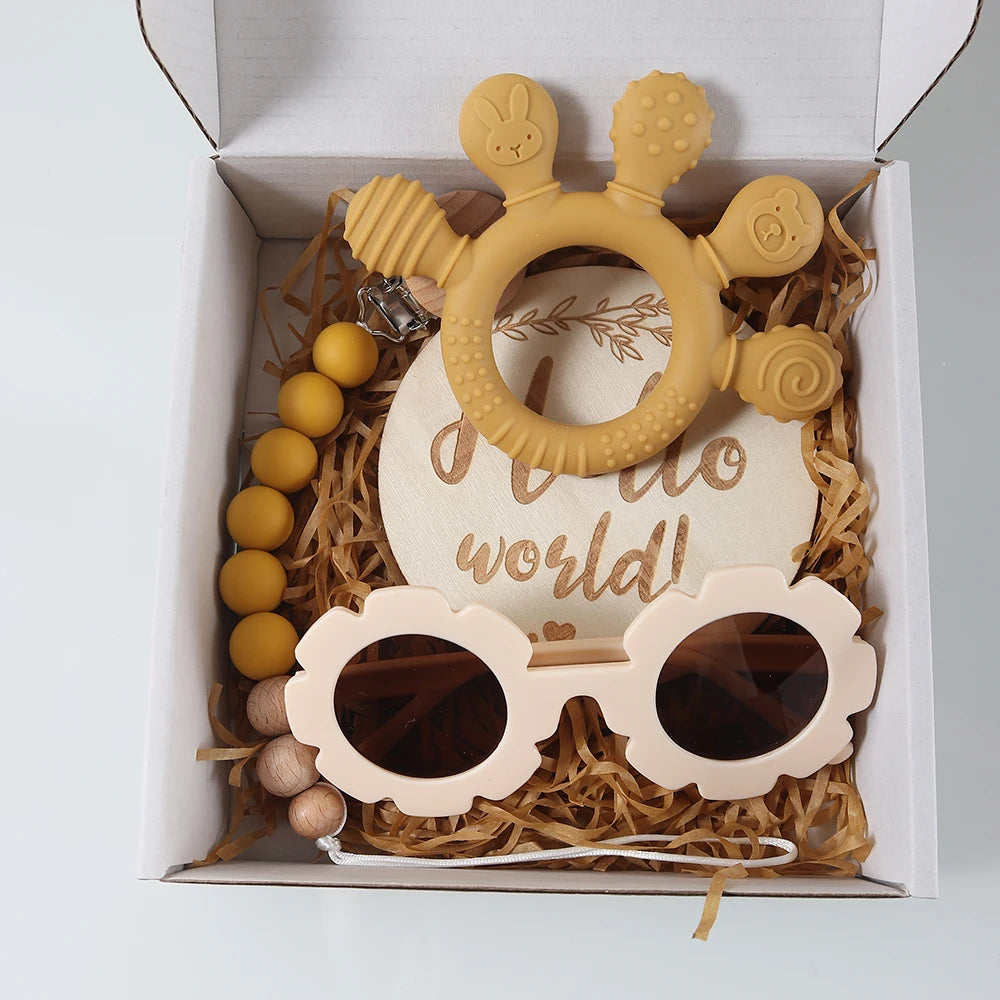 Baby teething toy set with sunglasses and teether in a decorative box.